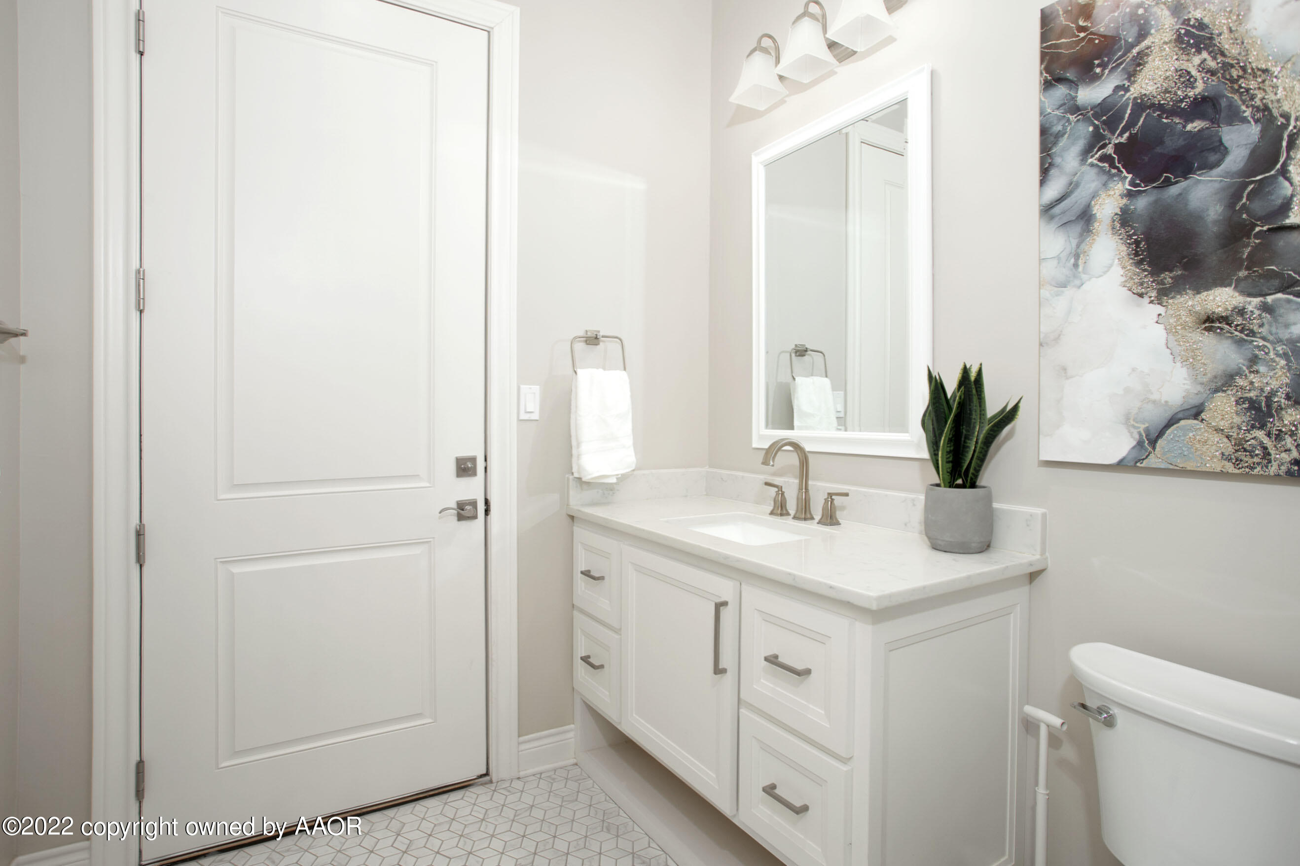 9101 Blackhawk Road Amarillo, TX 79119 - Photo 20 of 73 a bathroom with a granite countertop sink a toilet and with mirror