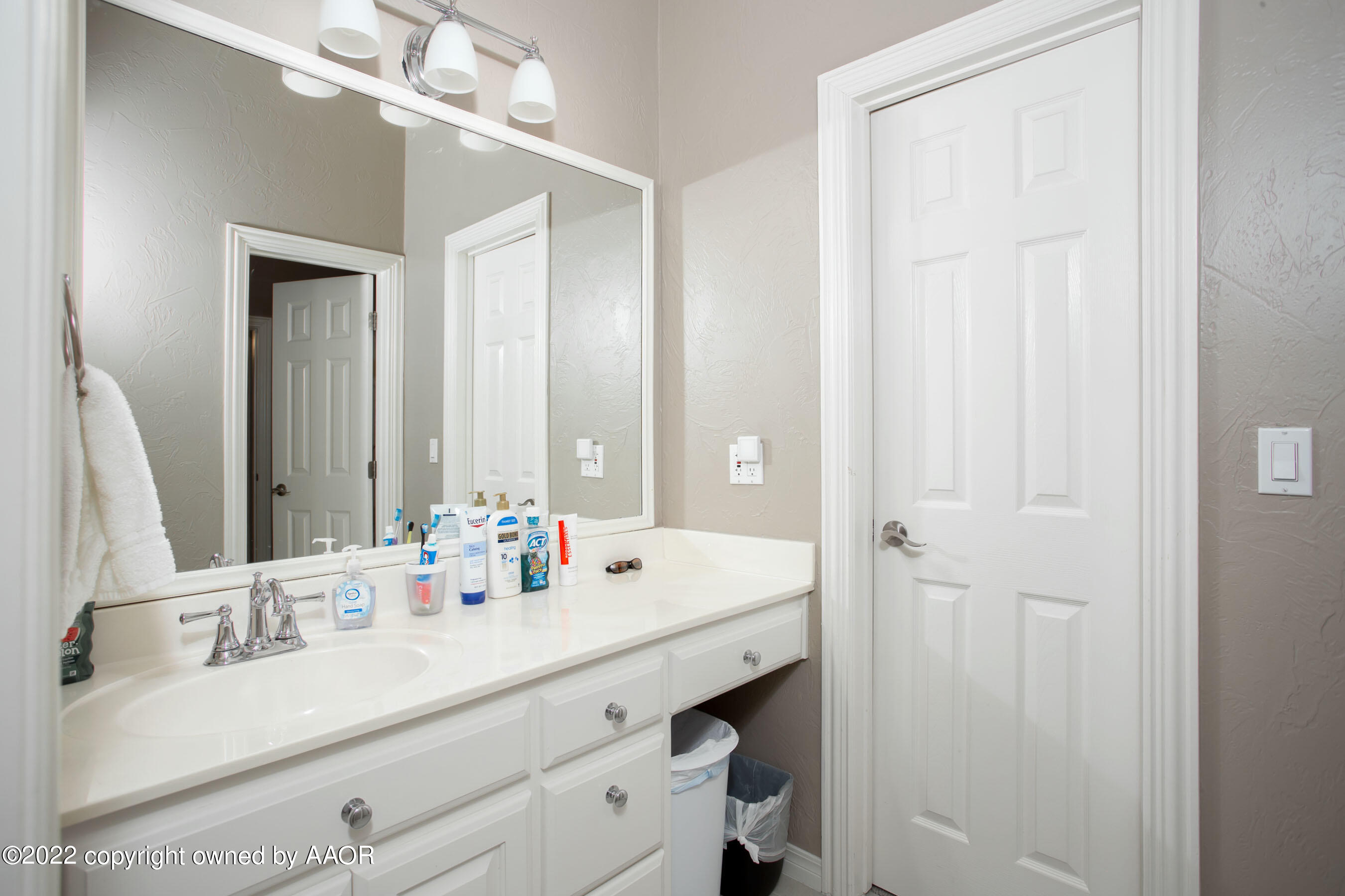 9101 Blackhawk Road Amarillo, TX 79119 - Photo 29 of 73 a bathroom with a double vanity sink and a mirror
