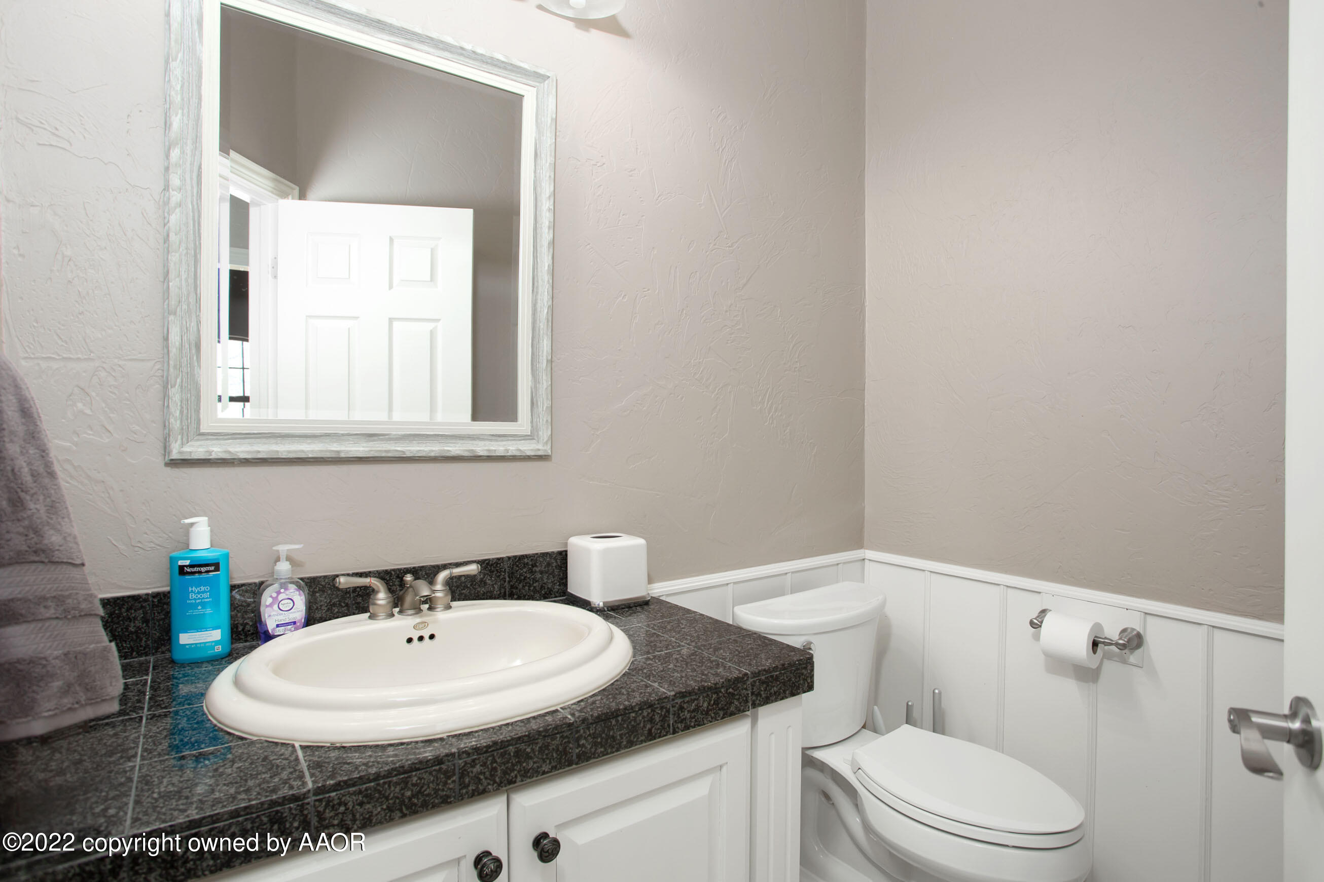 9101 Blackhawk Road Amarillo, TX 79119 - Photo 35 of 73 a bathroom with a granite countertop sink mirror vanity and toilet