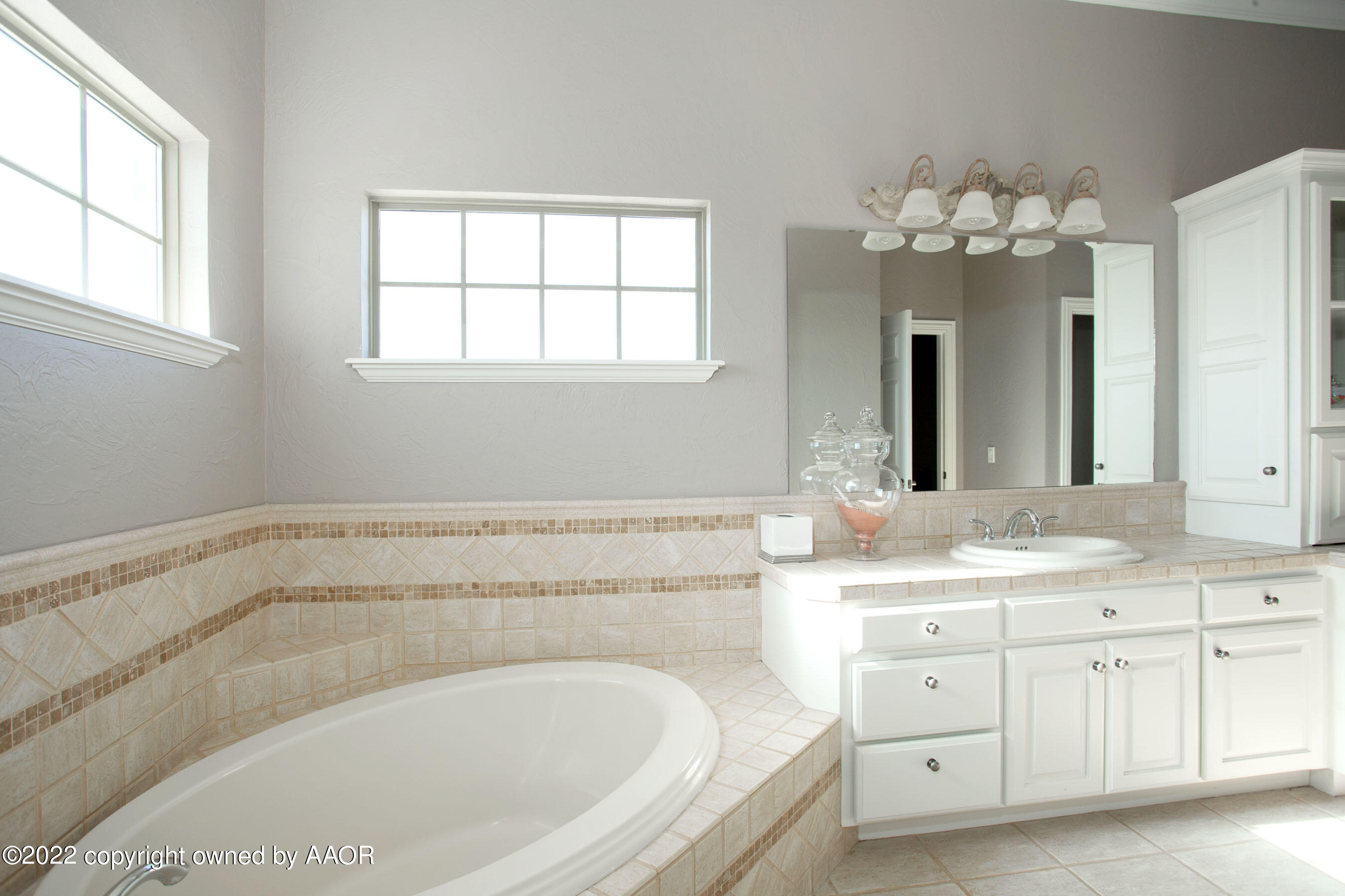 9101 Blackhawk Road Amarillo, TX 79119 - Photo 45 of 73 a spacious bathroom with a granite countertop sink mirror and a bathtub