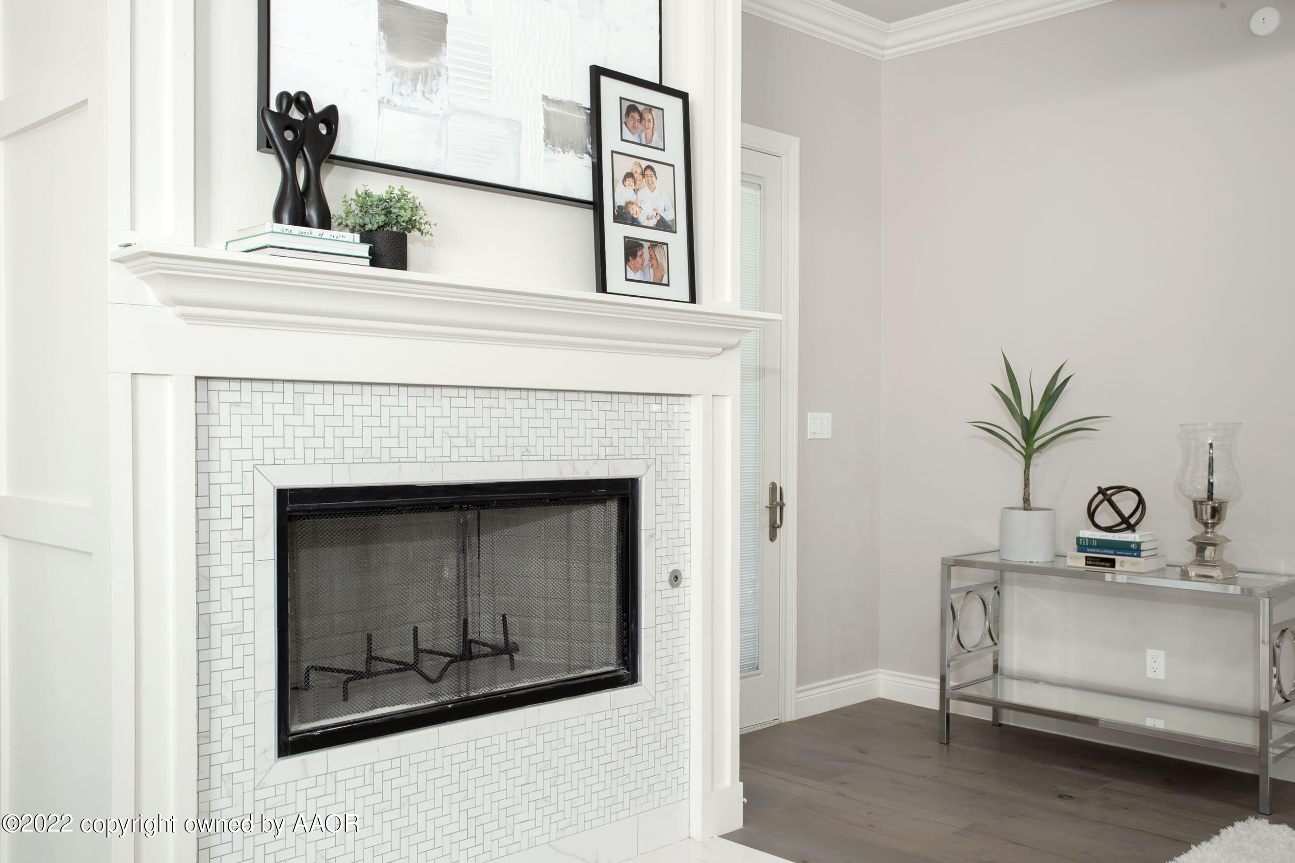 9101 Blackhawk Road Amarillo, TX 79119 - Photo 53 of 73 a living room with a fireplace and potted plants