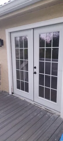 a view of empty room with wooden floor and floor to ceiling window