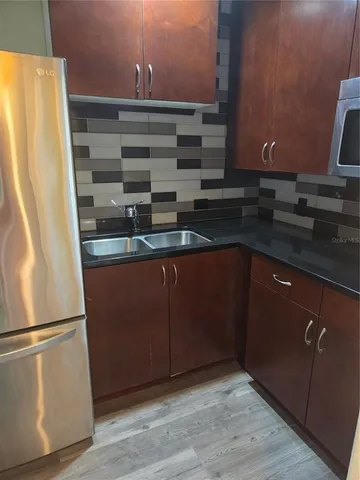 a kitchen with a refrigerator and a sink