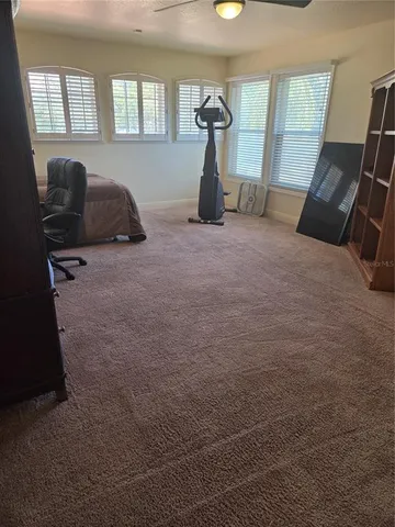 a bedroom with a bed and a chair