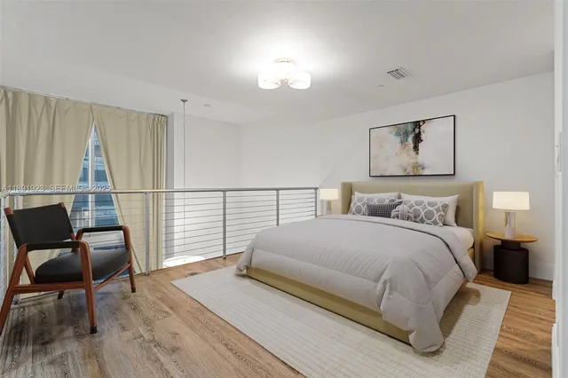 a bedroom with a bed and a chair