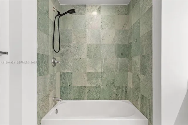 a white toilet sitting next to a shower