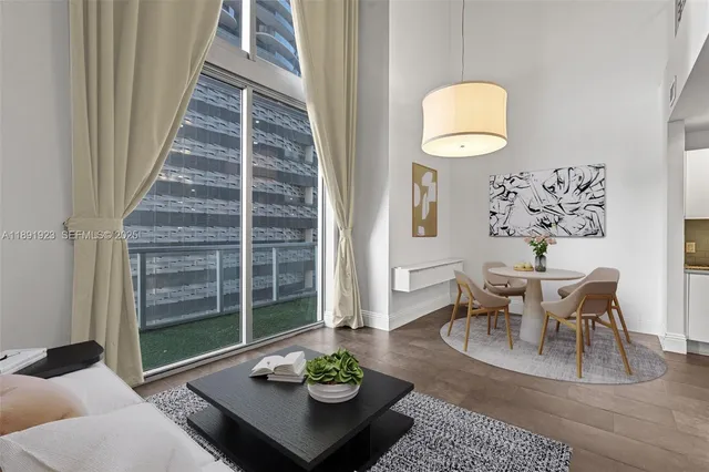 a view of a dining room with furniture window and wooden floor