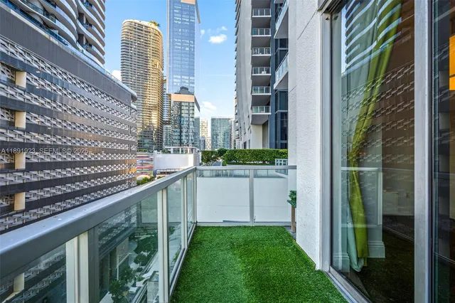 a view of a balcony with a yard