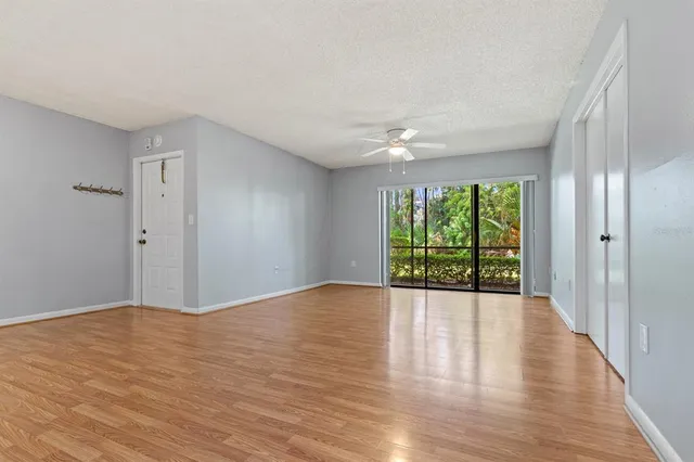 a view of a livingroom with wooden floor and an empty space
