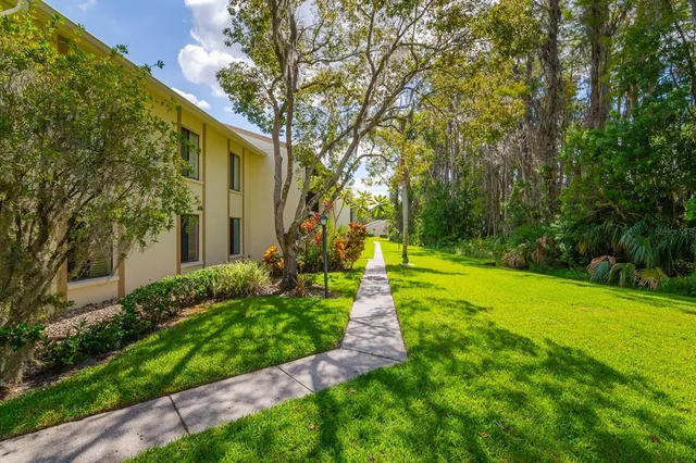 a view of a patio with a table and chairs under an umbrella