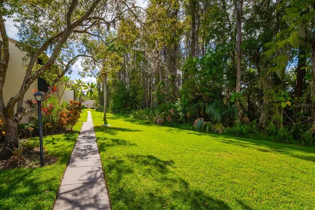 a view of staircase with railing and white walls