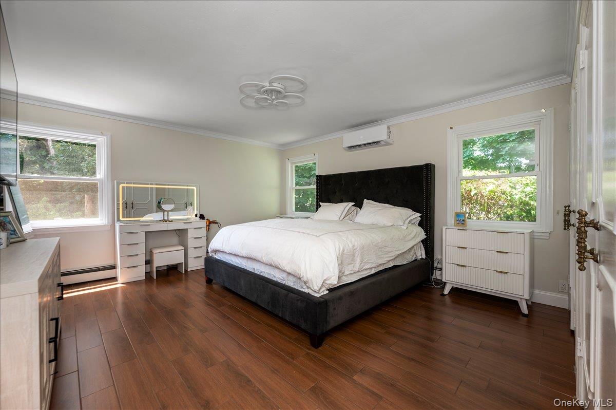 70 Longfellow Road Great Neck, NY 11023 - Photo 17 of 28 a bedroom with a bed and wooden floor