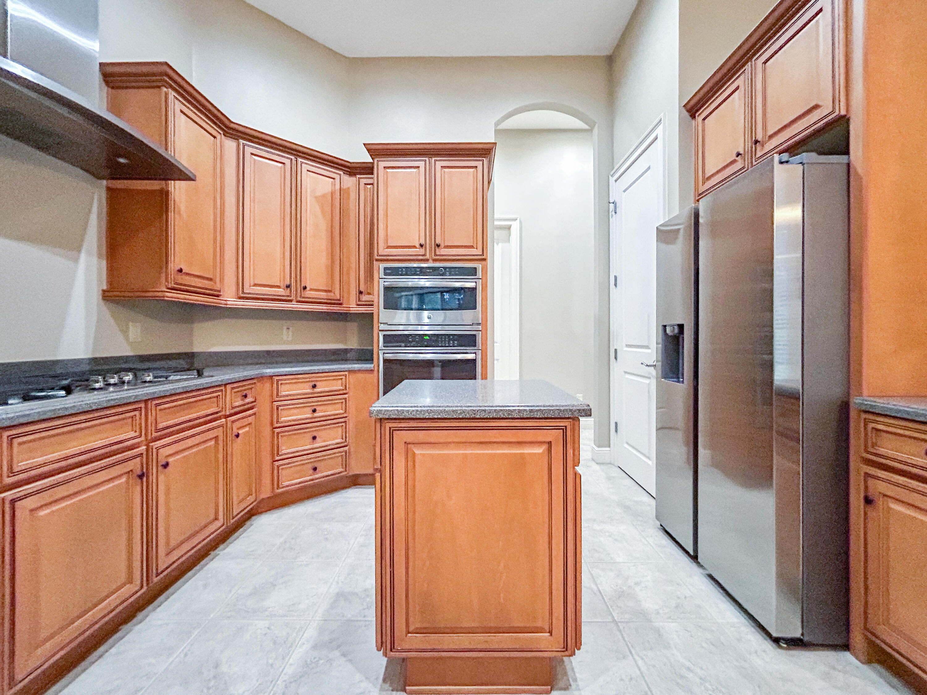 26345 San Gabriel Howey-in-the-Hills, FL 34737 - Photo 20 of 51 a kitchen with stainless steel appliances granite countertop a refrigerator and cabinets
