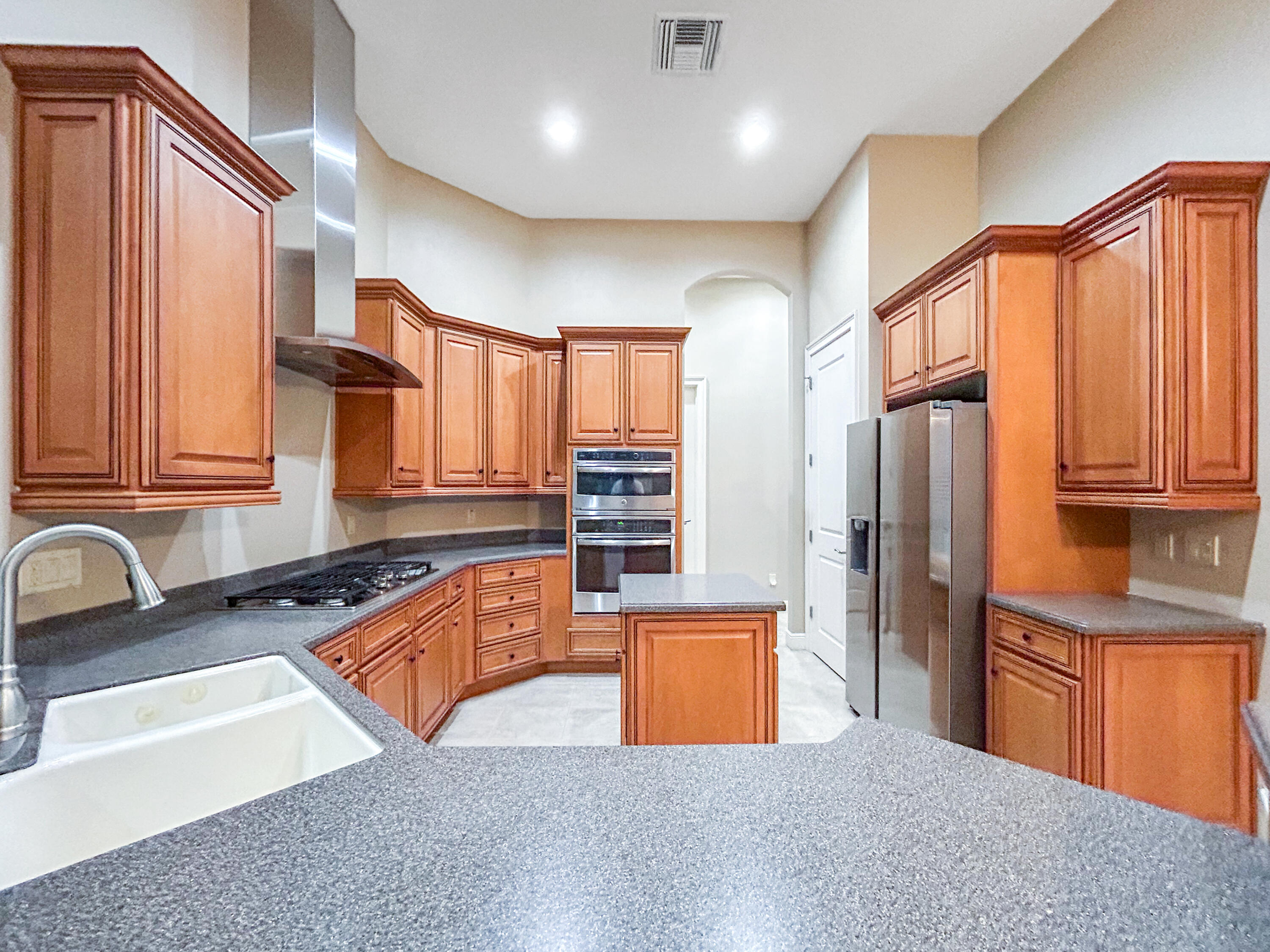 26345 San Gabriel Howey-in-the-Hills, FL 34737 - Photo 21 of 51 a view of kitchen with stainless steel appliances granite countertop a sink and a refrigerator