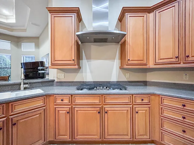 a kitchen with granite countertop cabinets and a wooden floor