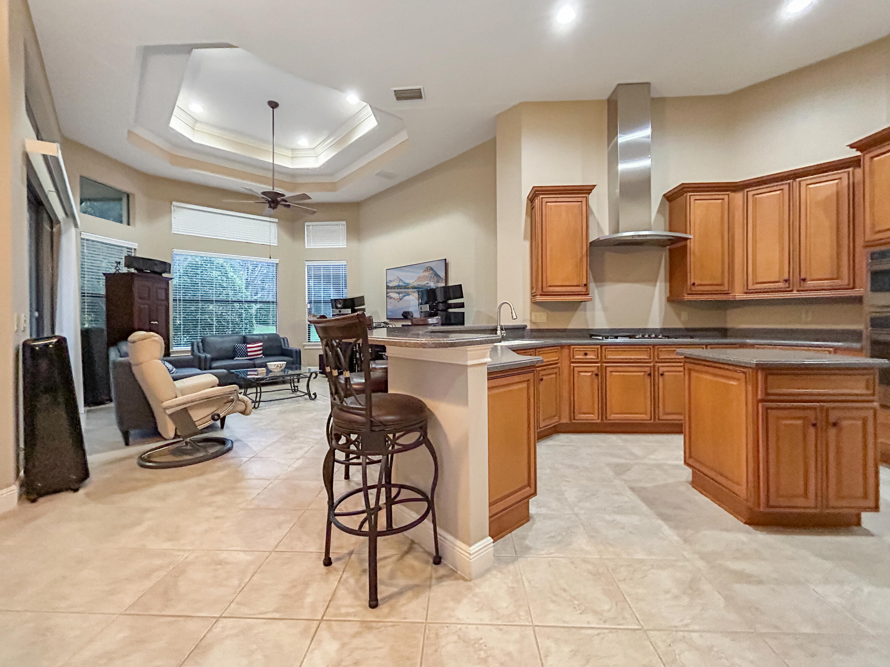 26345 San Gabriel Howey-in-the-Hills, FL 34737 - Photo 25 of 51 a kitchen with stainless steel appliances granite countertop a stove top oven a sink dishwasher and white cabinets with wooden floor
