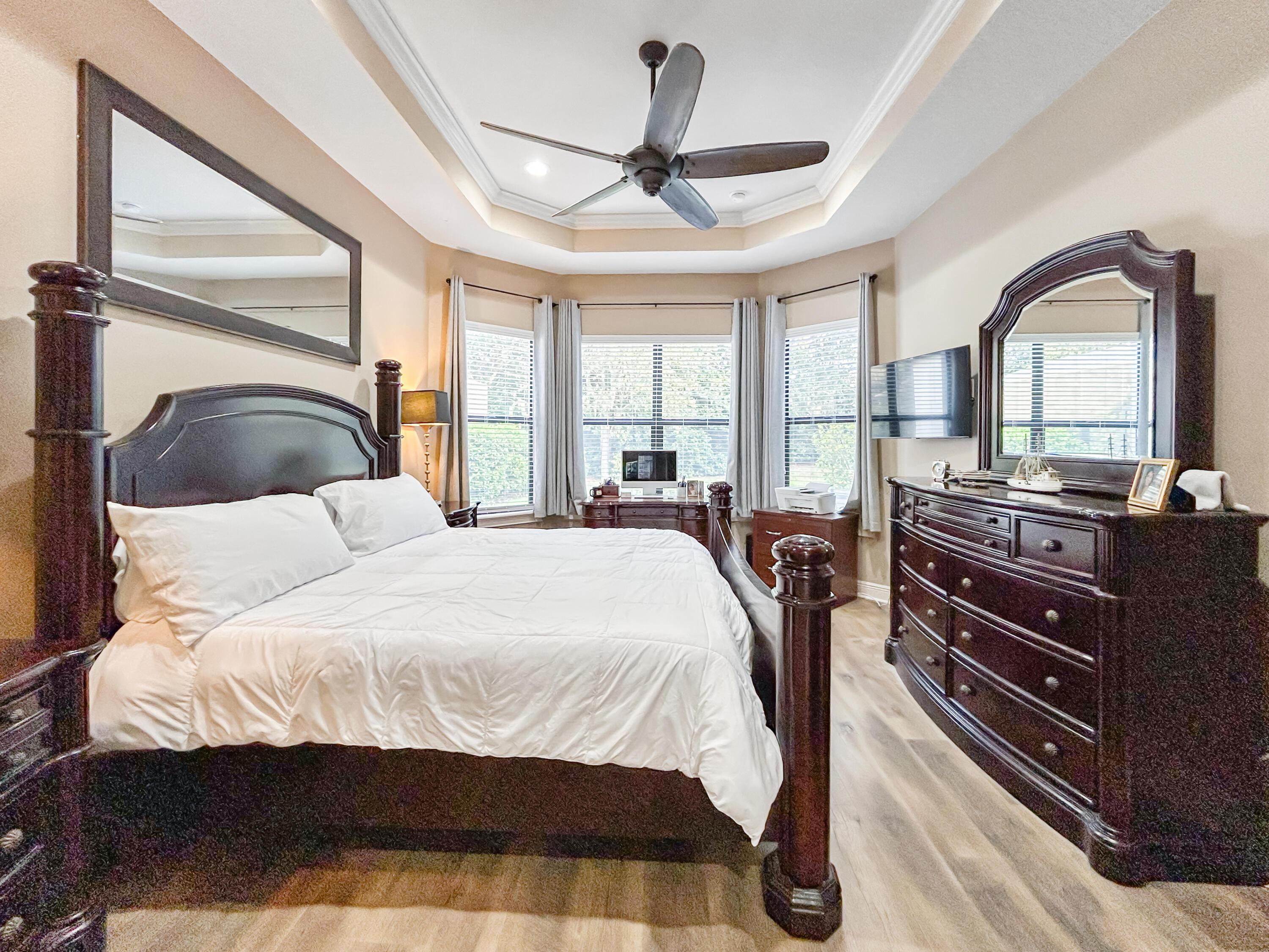 26345 San Gabriel Howey-in-the-Hills, FL 34737 - Photo 30 of 51 a bedroom with a bed next to a large window with the outer view