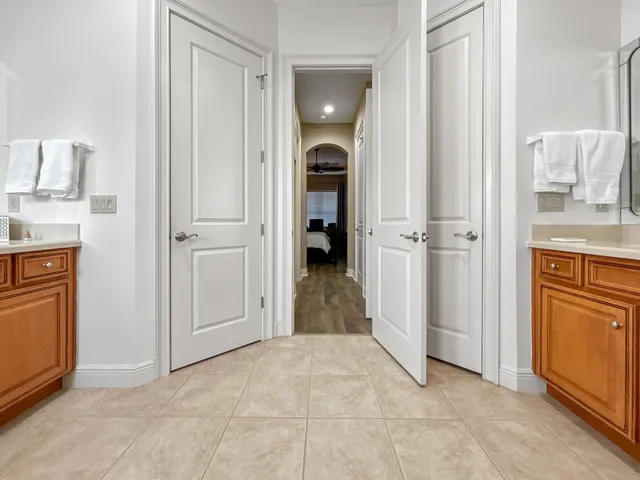 a spacious bathroom with a granite countertop sink mirror bathtub and toilet