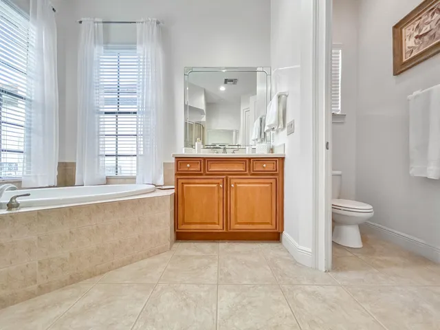 a bedroom with a large bed and a wooden floor