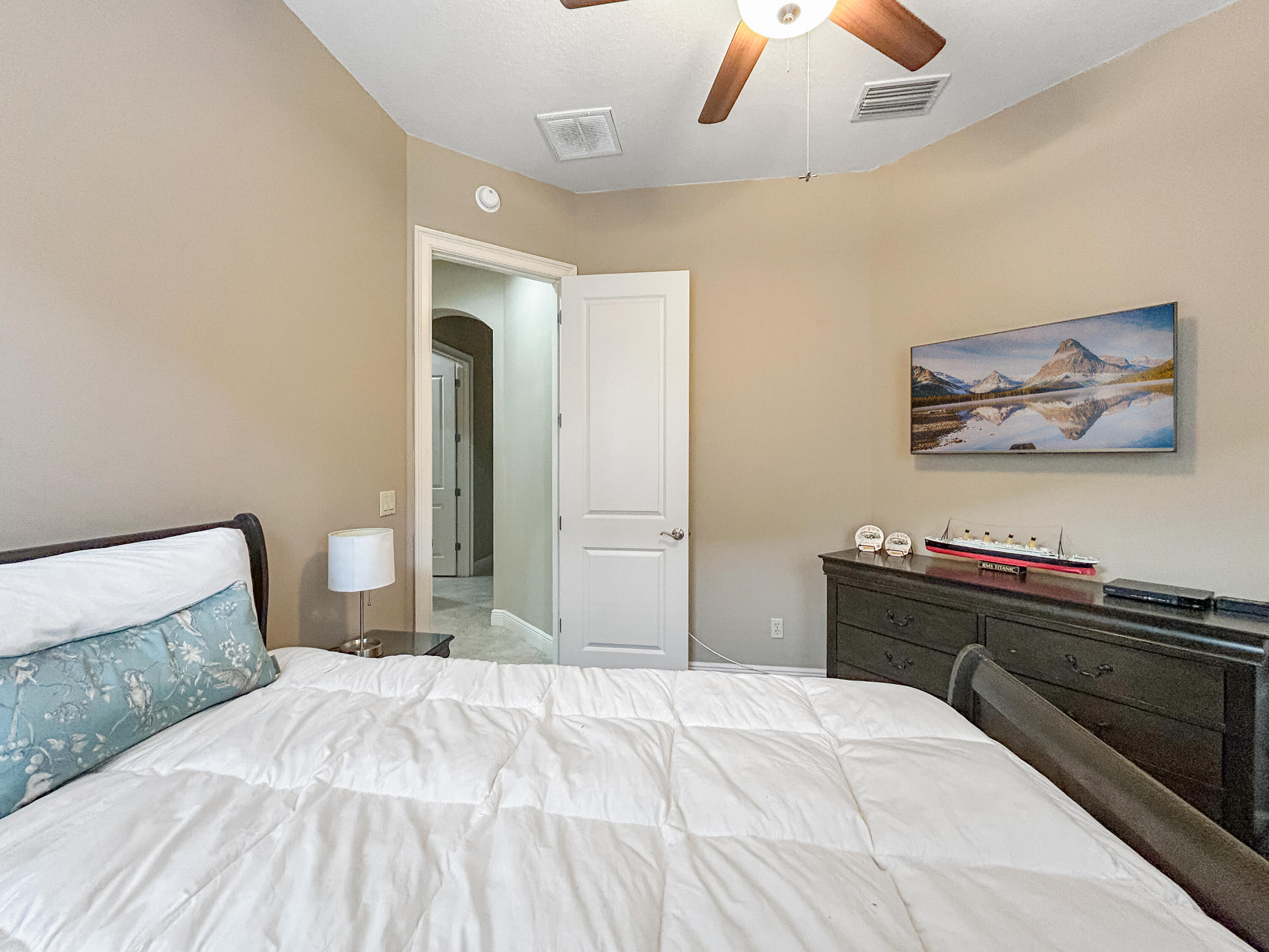 26345 San Gabriel Howey-in-the-Hills, FL 34737 - Photo 39 of 51 a bedroom with a bed and a chandelier