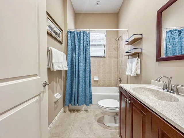 a bathroom with a toilet a sink a tub and mirror