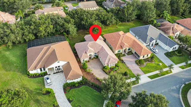 an aerial view of residential house with yard and mountain view in back