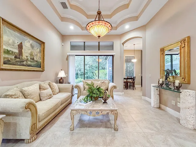 a living room with furniture and a chandelier