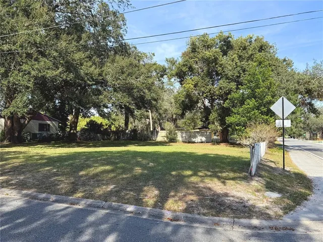 a view of a playground ground and trees