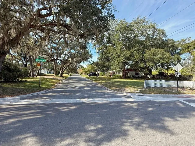 a view of a street with a park