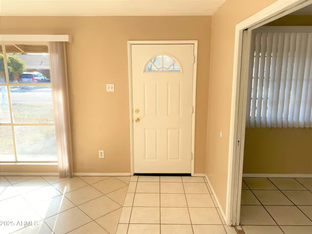 a view of an entryway with wooden floor