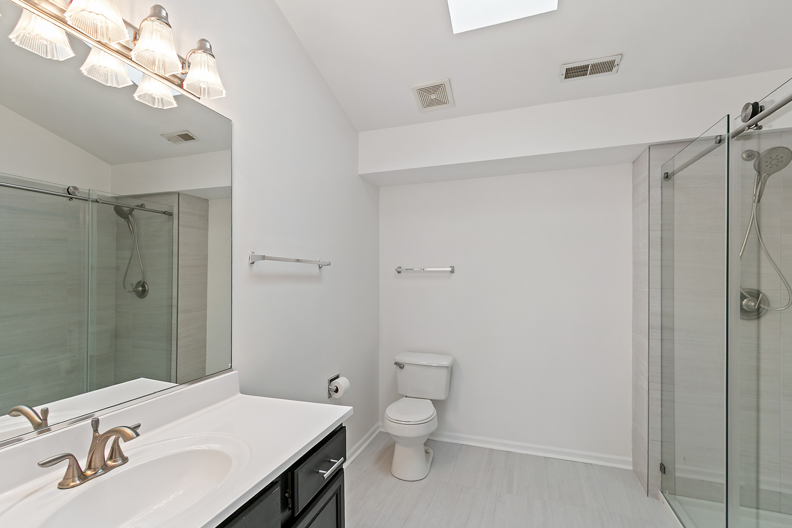 2604 Sheehan Court, Unit 204 Naperville, IL 60564 - Photo 11 of 19 a bathroom with a sink a toilet and shower