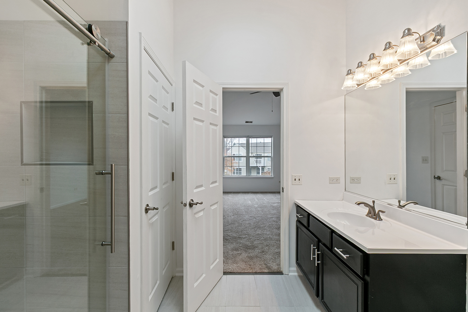 2604 Sheehan Court, Unit 204 Naperville, IL 60564 - Photo 12 of 19 a spacious bathroom with a double vanity sink mirror and shower