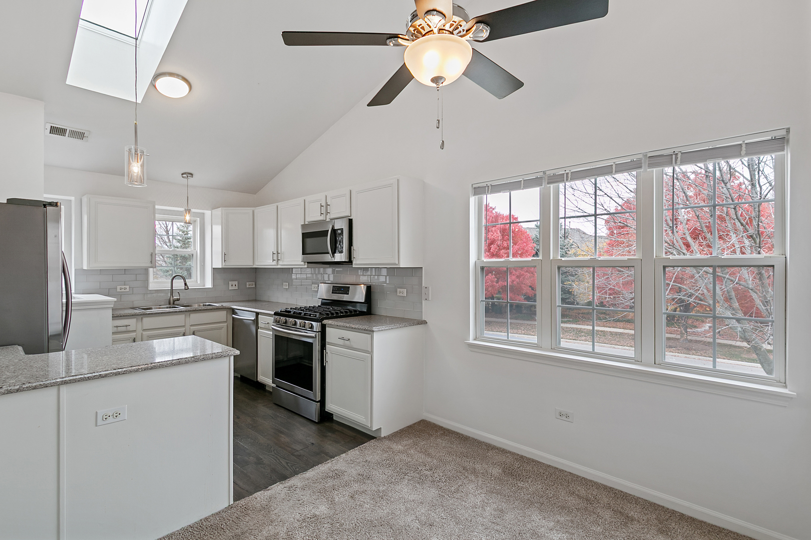 2604 Sheehan Court, Unit 204 Naperville, IL 60564 - Photo 6 of 19 a kitchen with stainless steel appliances granite countertop a stove a sink dishwasher a refrigerator and white cabinets with wooden floor