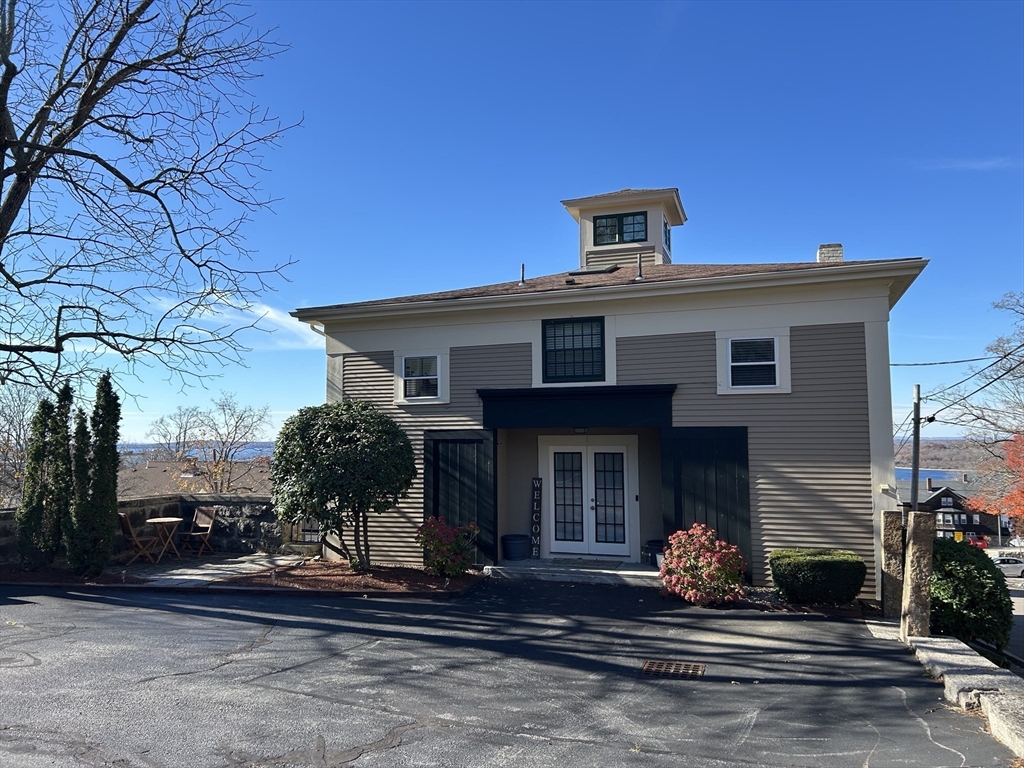 450 Rock Street, Unit 1 Fall River, MA 02720 - Photo 1 of 22 a front view of a house with a yard