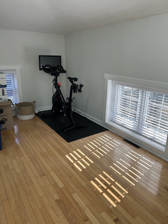 450 Rock Street, Unit 1 Fall River, MA 02720 - Photo 11 of 22 a view of a room with wooden floor and a ceiling fan