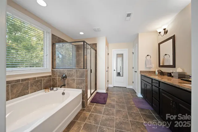 a bathroom with a bathtub sink and mirror