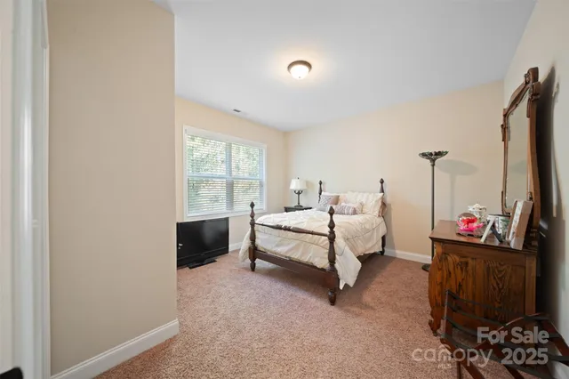 a spacious bedroom with a bed and a window