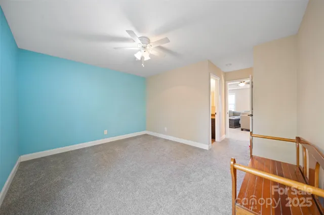 an empty room with fan and entrance