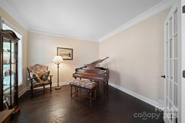 a living room with furniture and a piano