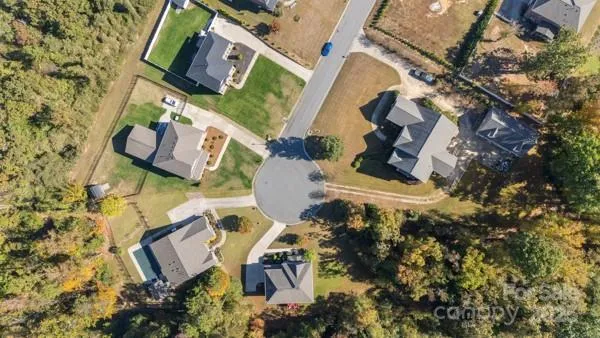 an aerial view of a house with outdoor space and street view