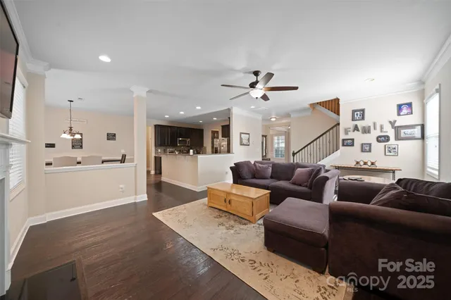 a living room with furniture and kitchen view