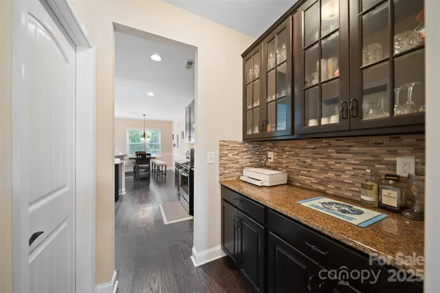 a kitchen with stainless steel appliances granite countertop a stove and cabinets