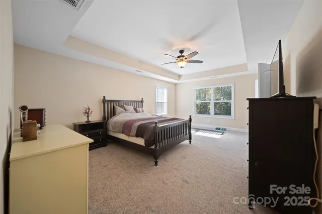 a bedroom with a bed dresser and a window