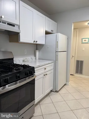a kitchen with a stove and a refrigerator