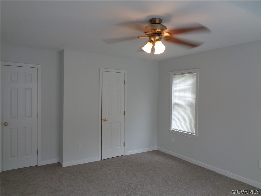 2411 Brookforest Road Midlothian, VA 23112 - Photo 11 of 24 an empty room with window and chandelier fan