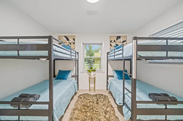 a bedroom with bunk bed and a desk