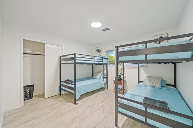 a bedroom with furniture and large window