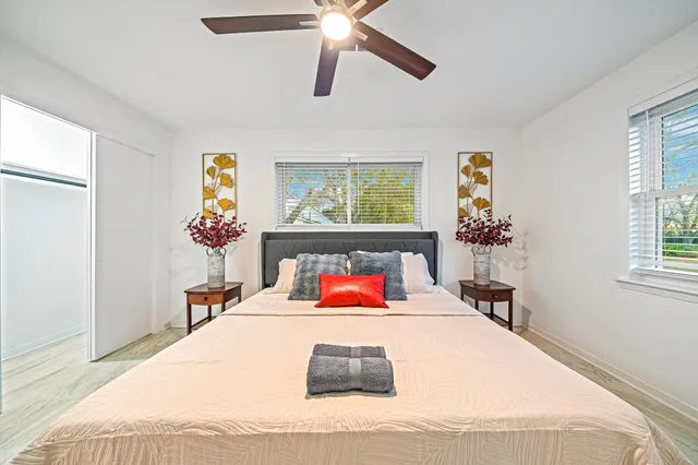 a bathroom with a granite countertop sink a toilet a mirror and shower