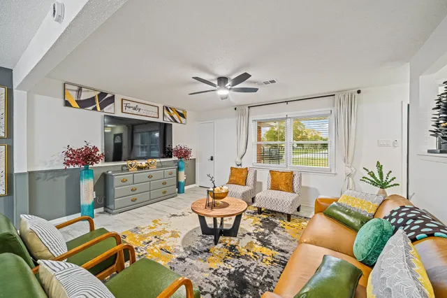 a living room with furniture and a large window