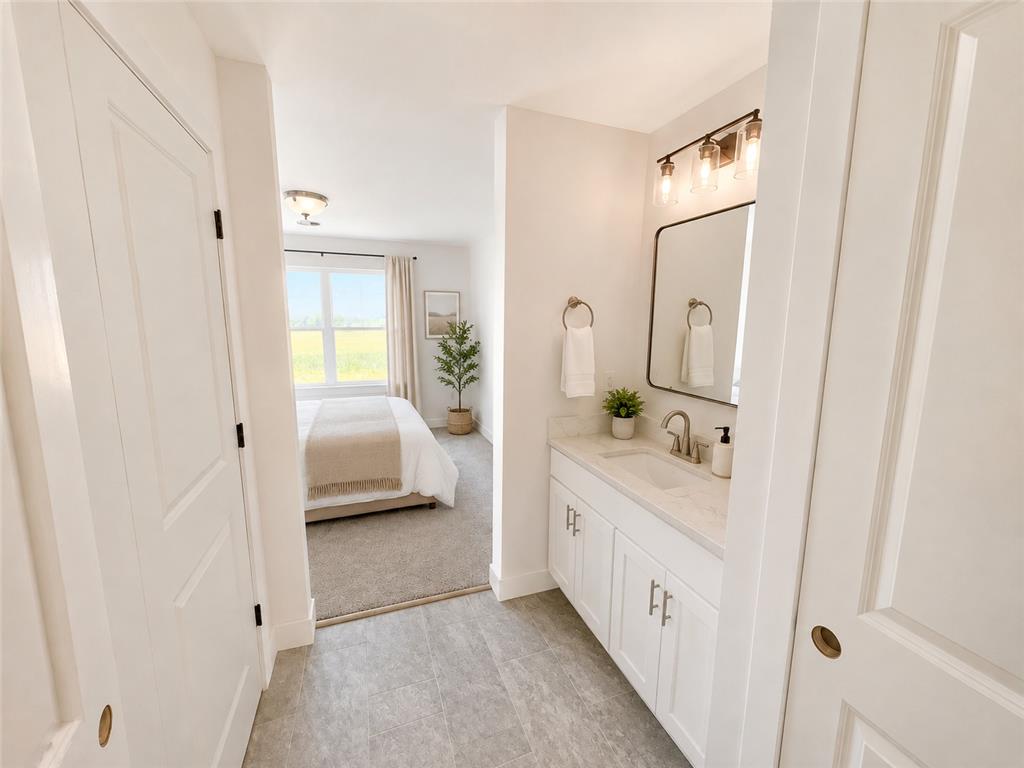 3104 Moyer Road Hellertown, PA 18055 - Photo 16 of 30 A modern vanity with stone counters seamlessly connects to an adjacent bedroom suite.